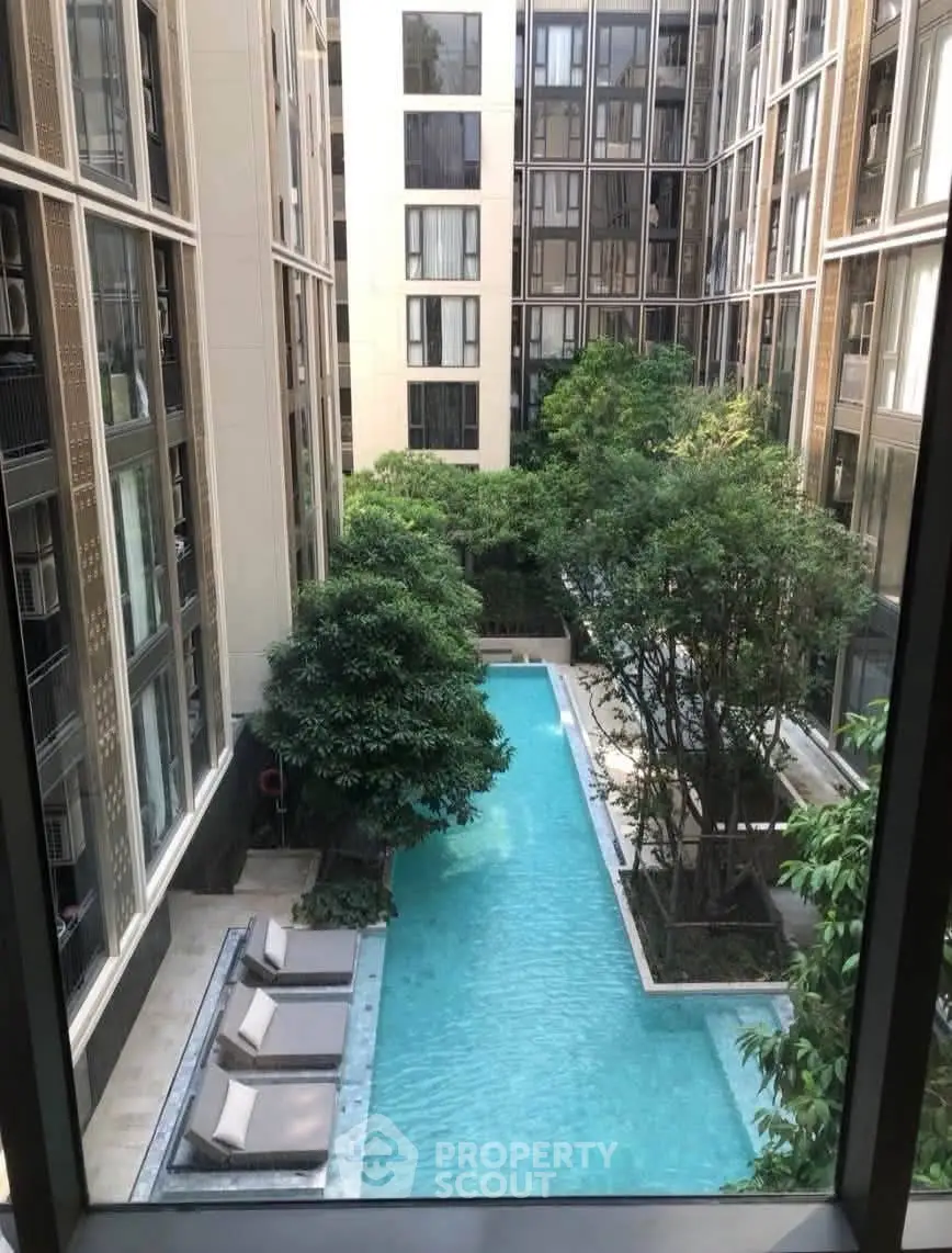 Luxurious apartment complex with stunning pool view and lush greenery