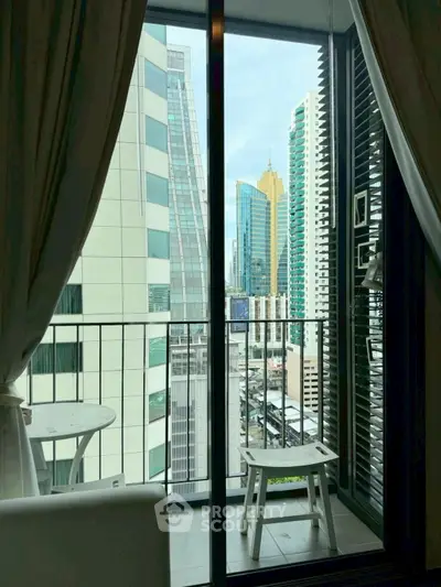 Modern balcony with city view and stylish furniture in urban apartment.