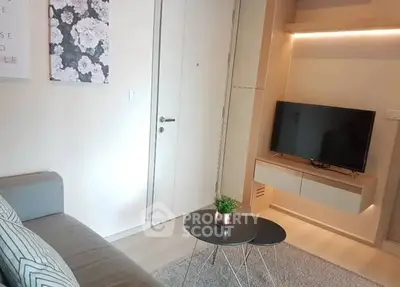 Modern living room with sleek TV unit and cozy seating area