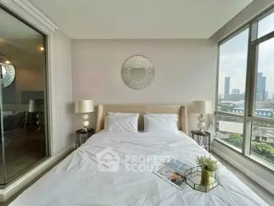 Modern bedroom with city view, stylish decor, and ample natural light in urban apartment.