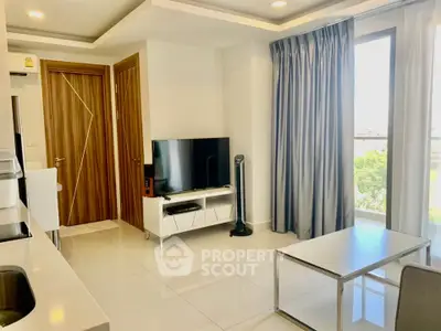 Modern living room with sleek design, featuring a large TV, stylish furniture, and a view of greenery through large windows.