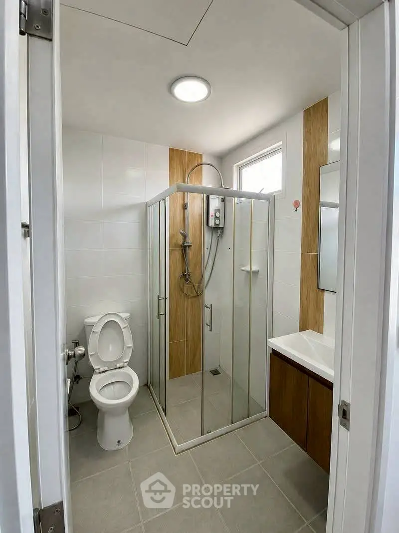 Modern bathroom with glass shower enclosure and sleek fixtures