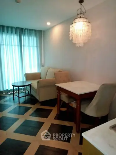 Chic living room with elegant chandelier and cozy seating area