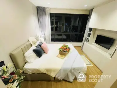 Luxurious bedroom with city view, modern decor, and cozy ambiance