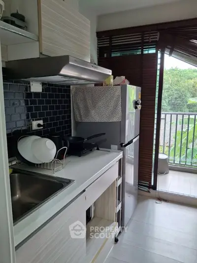 Modern kitchen with sleek design and balcony view