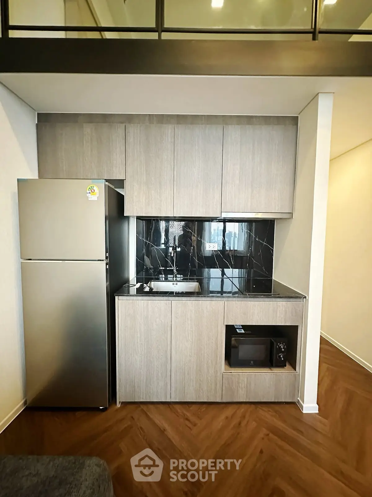 Modern compact kitchen with sleek cabinetry and stainless steel appliances