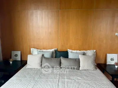 Cozy bedroom with wooden accent wall and stylish bedding