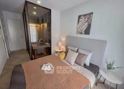 Cozy modern bedroom with stylish decor and soft lighting, featuring a comfortable bed and elegant furnishings.