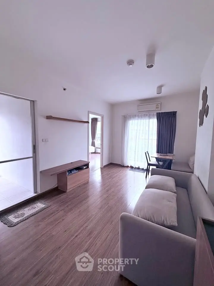 Spacious living room with modern decor and natural light