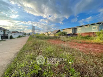 Expansive vacant land with potential for development under a vibrant sky, ideal for residential or commercial projects.
