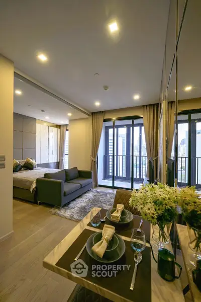Modern open-plan living room with balcony view in a stylish apartment