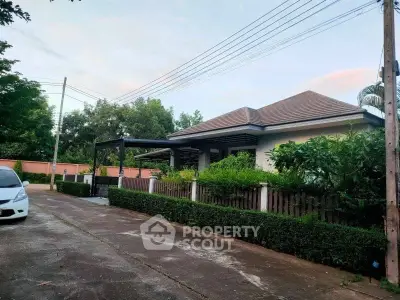 Charming suburban home with lush greenery and spacious driveway, perfect for family living.