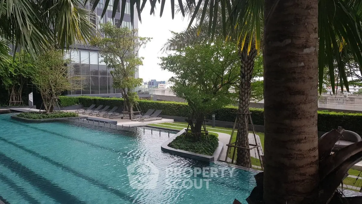 Luxurious outdoor pool area with lush greenery and modern design