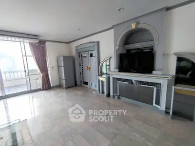 Spacious living room with elegant decor and city view balcony