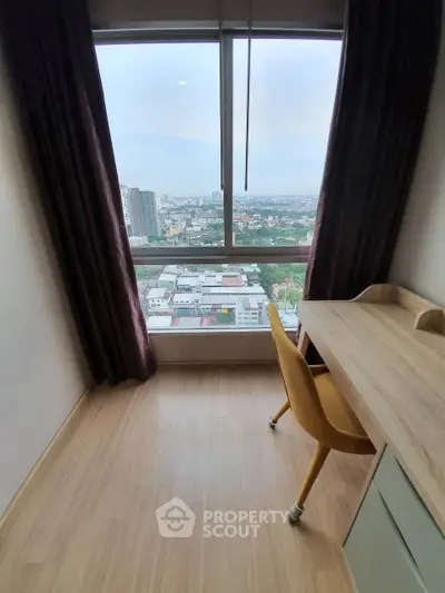 High-rise apartment study with panoramic city view and modern desk setup.