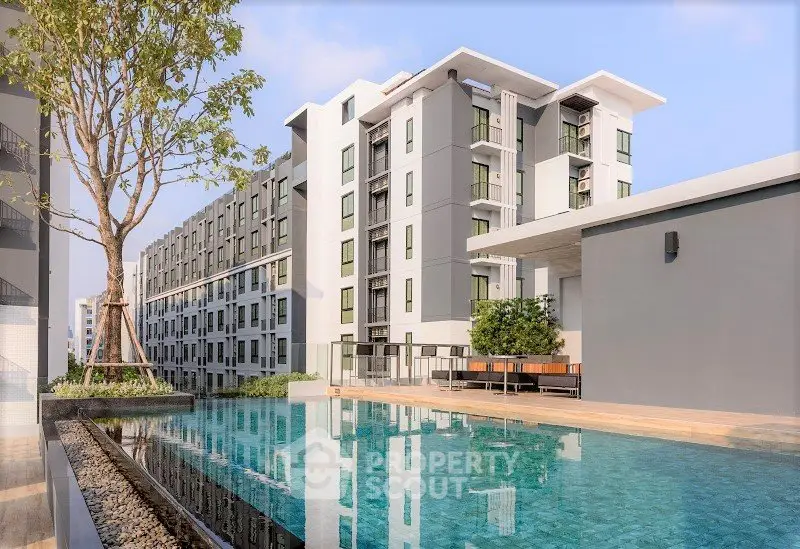 Modern apartment complex with a luxurious pool and landscaped surroundings, perfect for urban living.