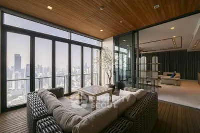 Luxurious modern living room with panoramic city view and elegant decor.