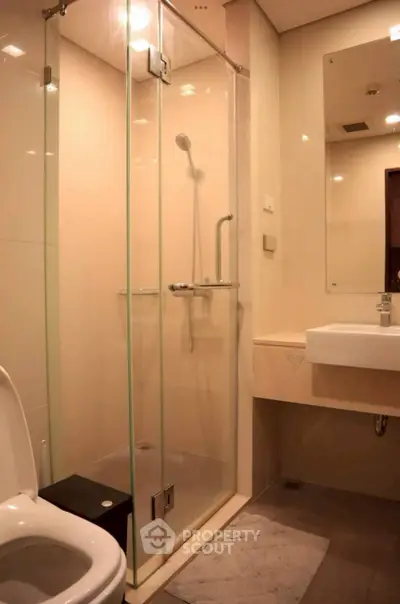 Modern bathroom with glass shower and sleek fixtures