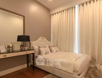 Elegant bedroom with plush bed, stylish decor, and soft lighting for a cozy ambiance.