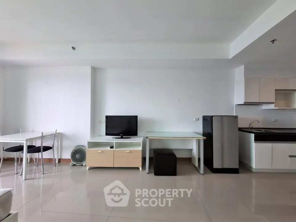 Modern open-plan living room with sleek kitchen and dining area