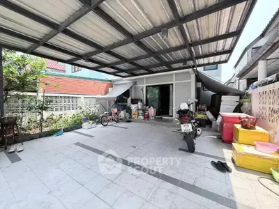 Spacious covered outdoor area with ample storage and parking space