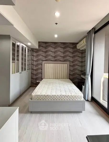 Modern bedroom with stylish decor and large windows for natural light.