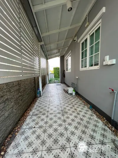 Charming covered walkway with decorative tiles and modern exterior design