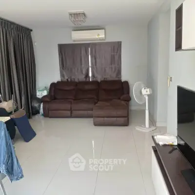 Spacious living room with modern furniture and air conditioning