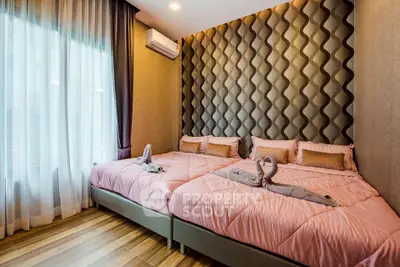 Luxurious bedroom with stylish decor and twin beds in modern apartment