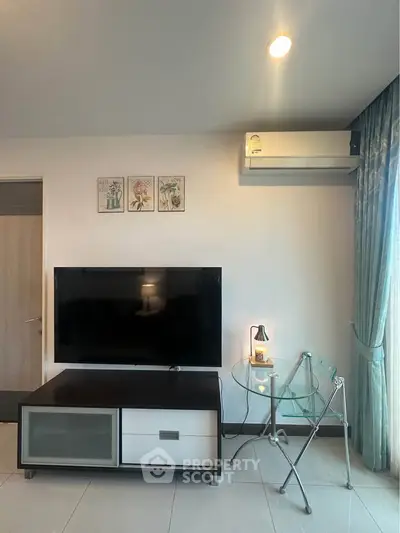 Modern living room with TV, air conditioning, and stylish decor.