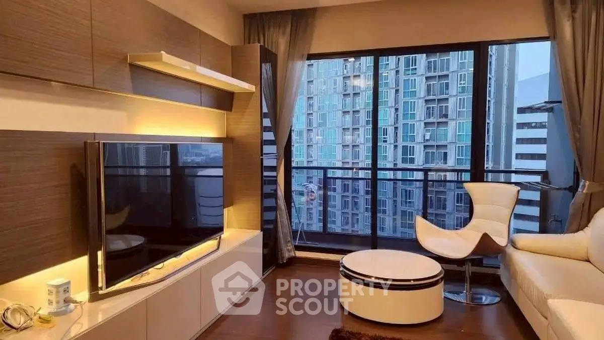 Modern living room with large windows and city view, featuring stylish furniture and ambient lighting.
