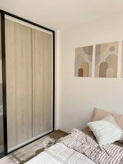 Modern bedroom with stylish decor and sliding wardrobe doors