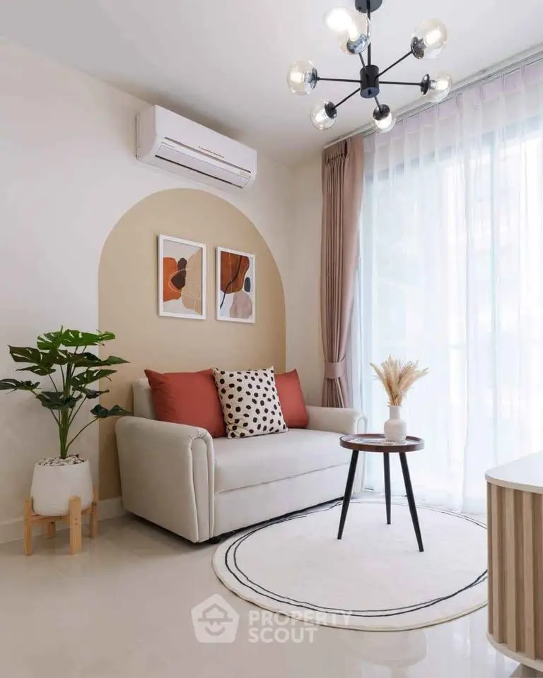 Stylish living room with modern decor, featuring a cozy sofa, chic lighting, and large windows for natural light.
