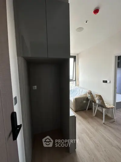 Modern apartment interior with sleek design and natural light, featuring a cozy living area and stylish flooring.