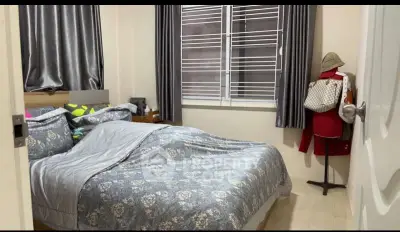 Cozy bedroom with stylish decor and ample natural light, perfect for relaxation and comfort.