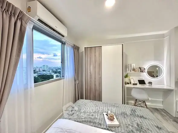 Modern bedroom with city view, featuring stylish decor and natural light.