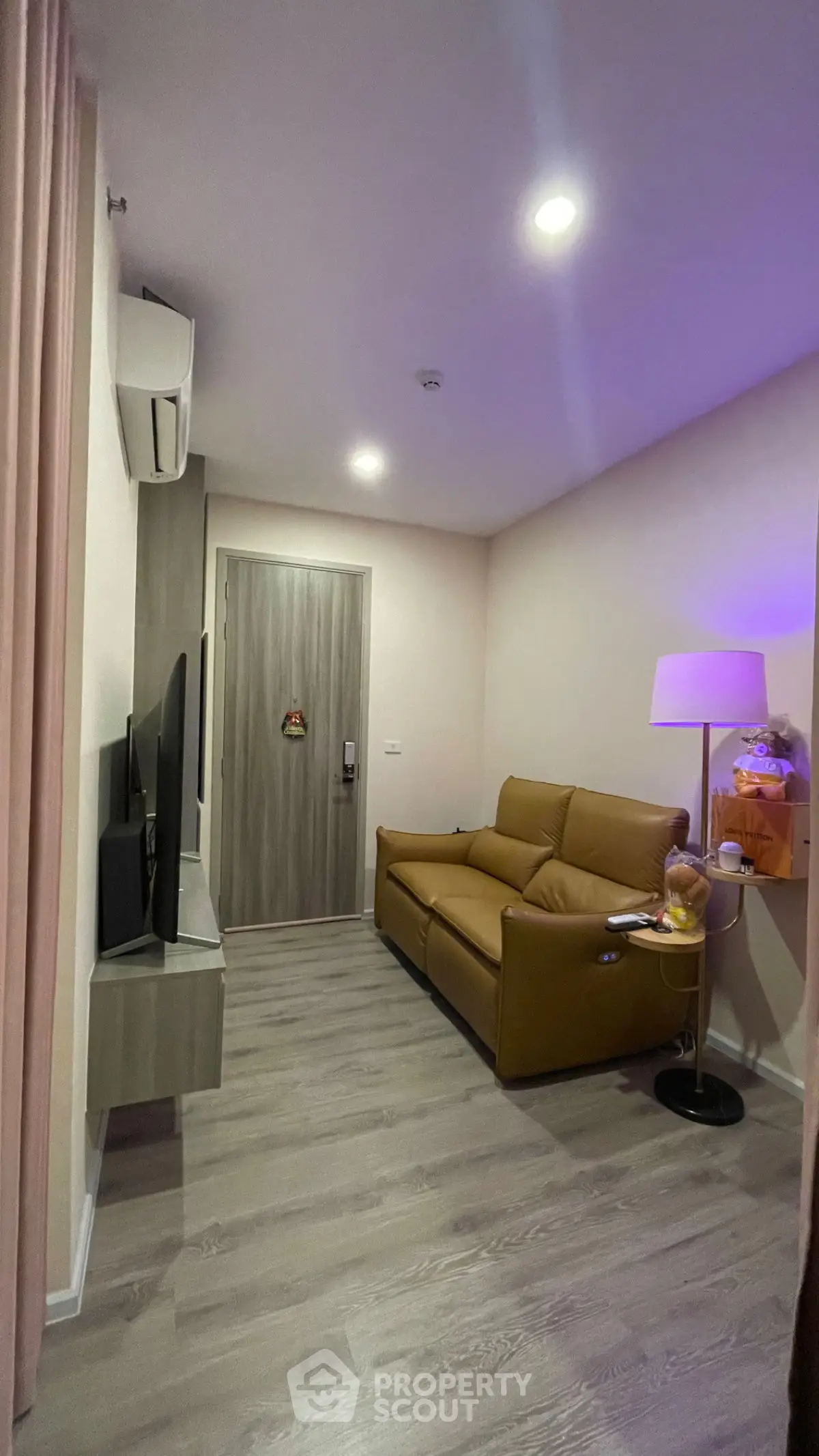 Cozy living room with modern decor and comfortable seating in a stylish apartment.