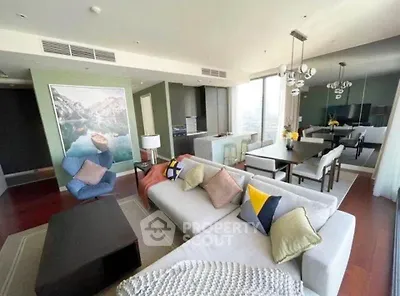 Spacious modern living room with elegant dining area and large windows offering city views.