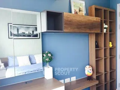 Stylish modern bedroom with blue accent wall and wooden shelving