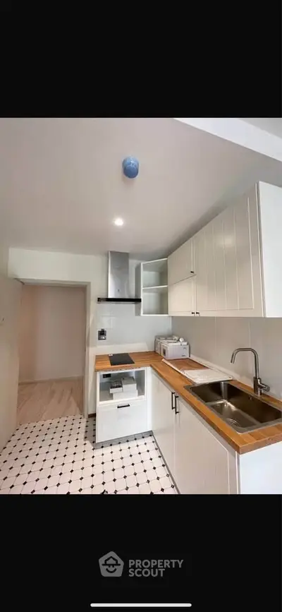 Modern kitchen with sleek cabinetry and wooden countertops