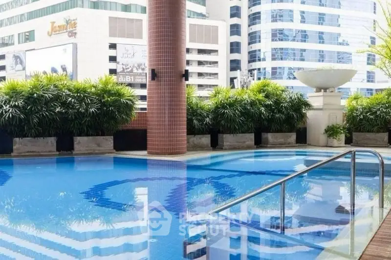 Luxurious rooftop pool with cityscape views in modern high-rise building.