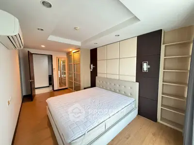 Spacious modern bedroom with elegant design and ample storage in prime real estate location.