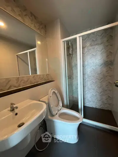 Modern bathroom with sleek fixtures and glass shower enclosure