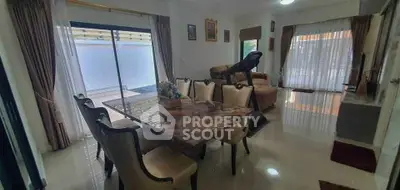 Spacious living room with elegant dining area and modern treadmill, perfect for family gatherings.