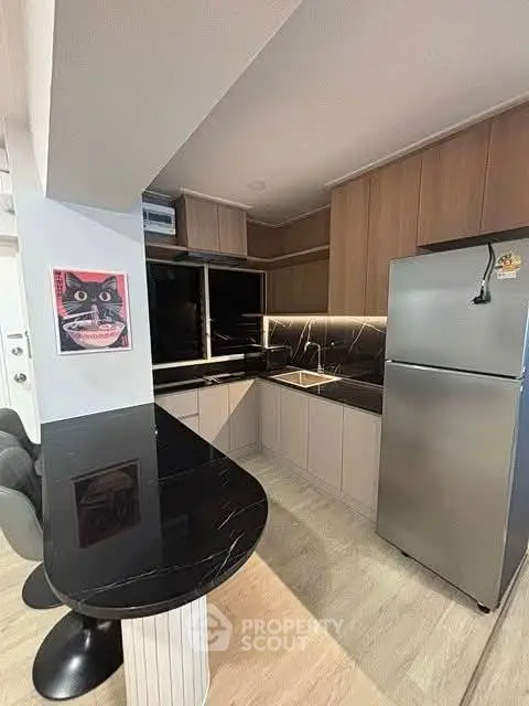 Modern kitchen with sleek black countertops and stainless steel appliances