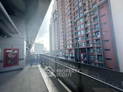 Modern high-rise apartment building with spacious balcony and city view