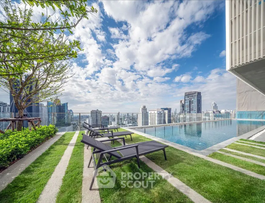 Luxurious rooftop pool with stunning city skyline views and modern lounge chairs.