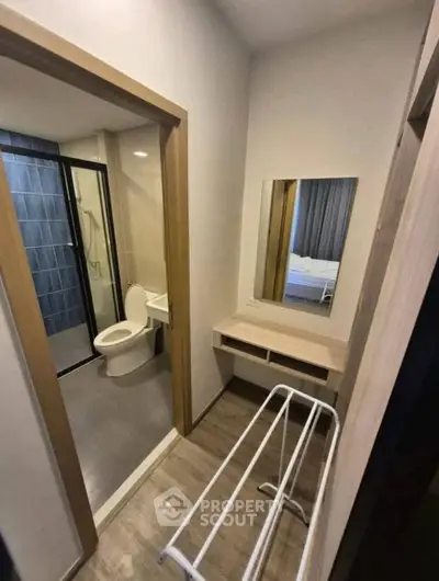Modern apartment bathroom with sleek design and convenient amenities.
