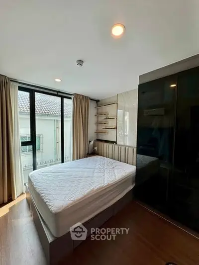 Modern bedroom with large window and stylish decor