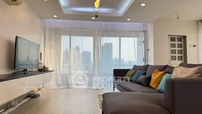 Modern living room with city view, featuring sleek furniture and large windows for natural light.